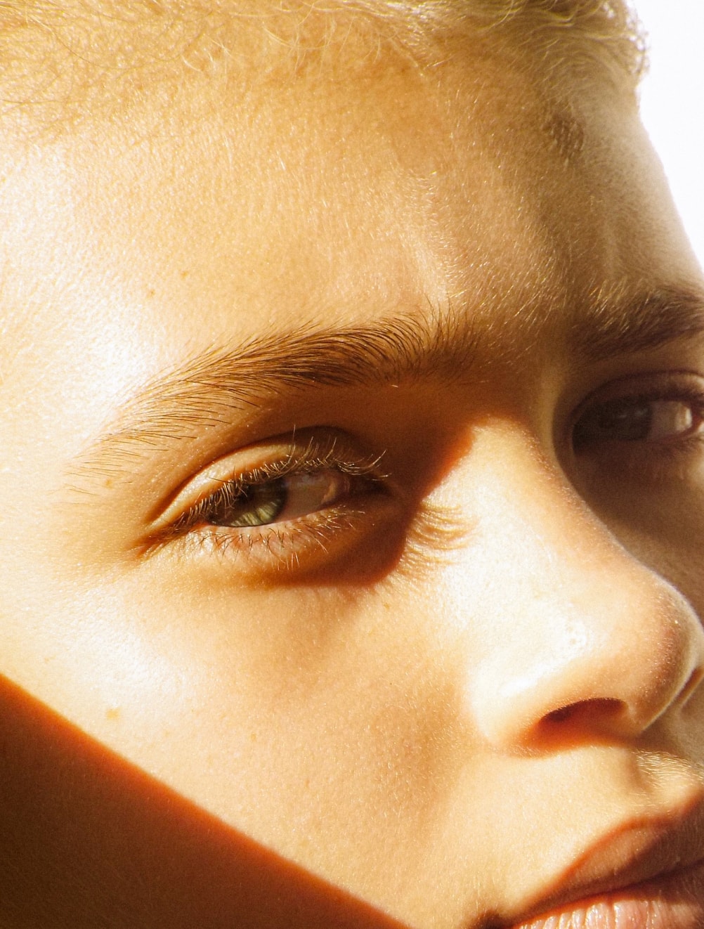 woman looking sideways with sun on her face