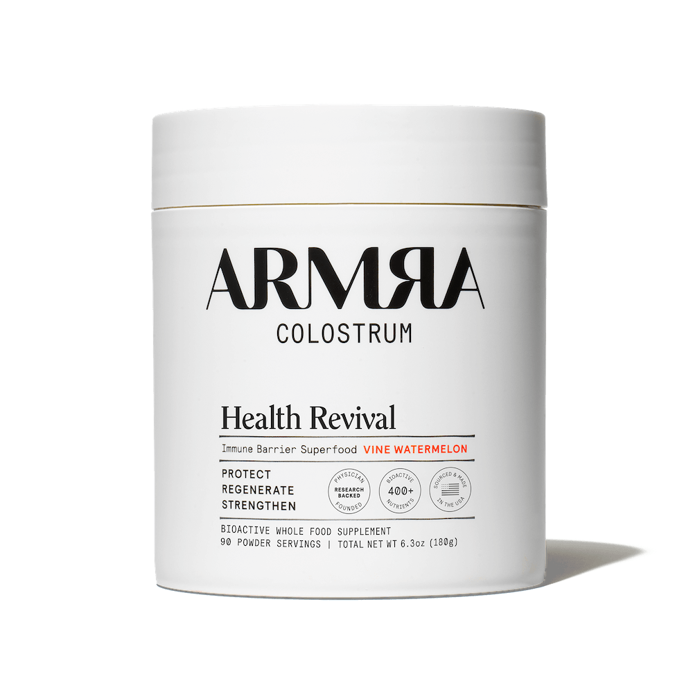 ARMRA Colostrum Health Revival supplement container on a black background